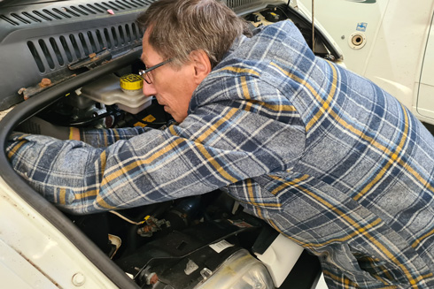 Chris Blackwell of Shropshire Motorhome Services working on campervan engine repairs